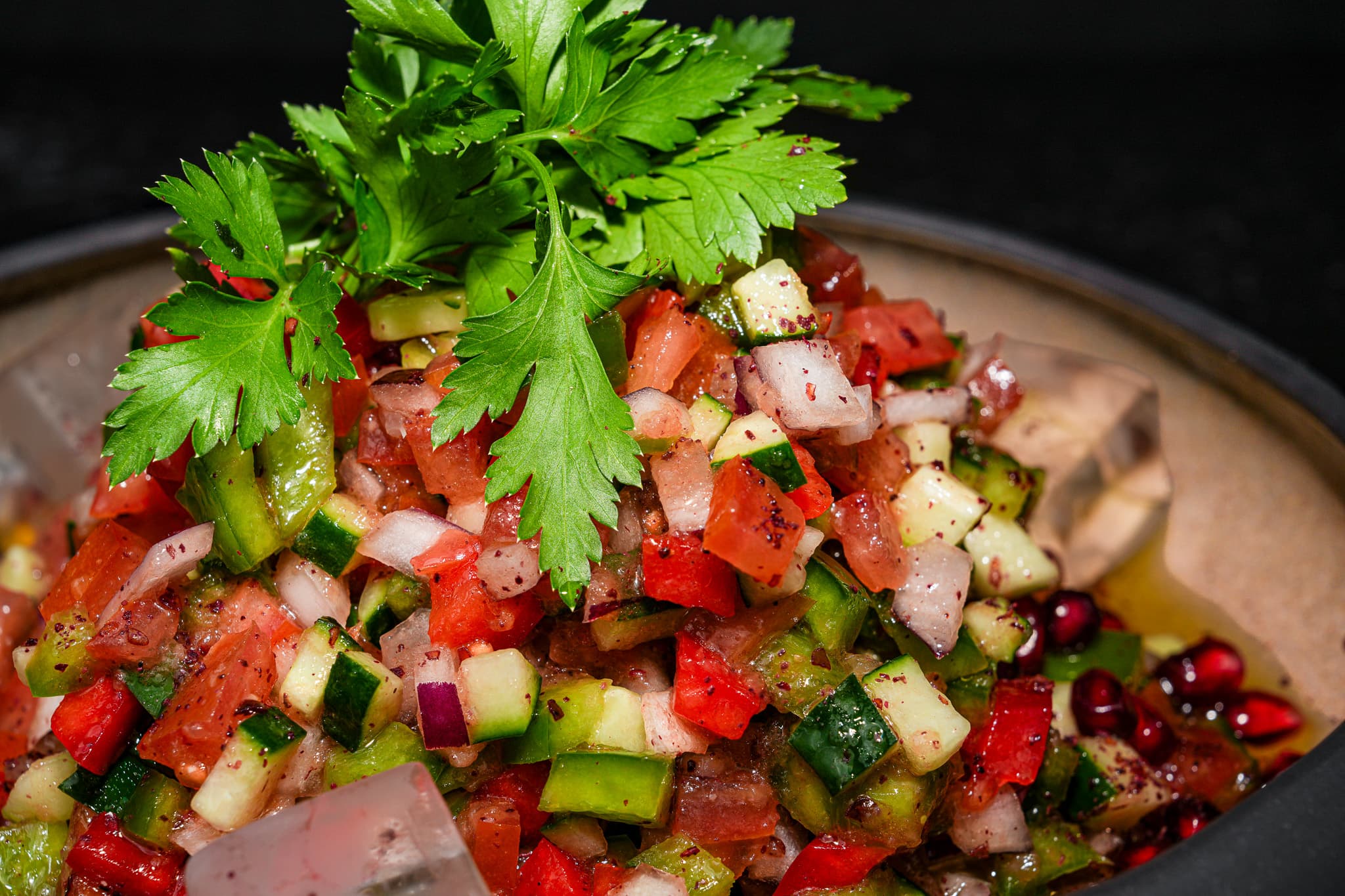 Close-up of a chopped Turkish salad with pomegranate and herbs