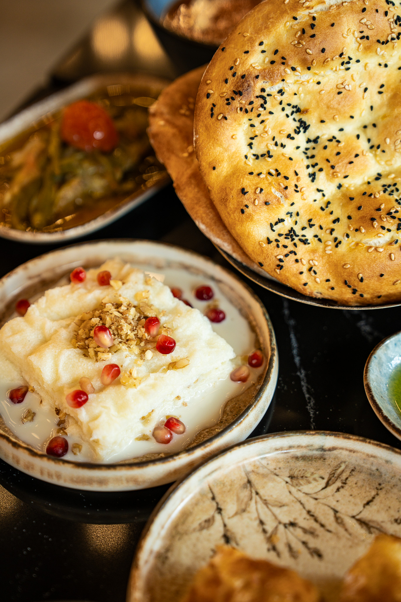 Güllaç dessert with pomegranate and pide bread