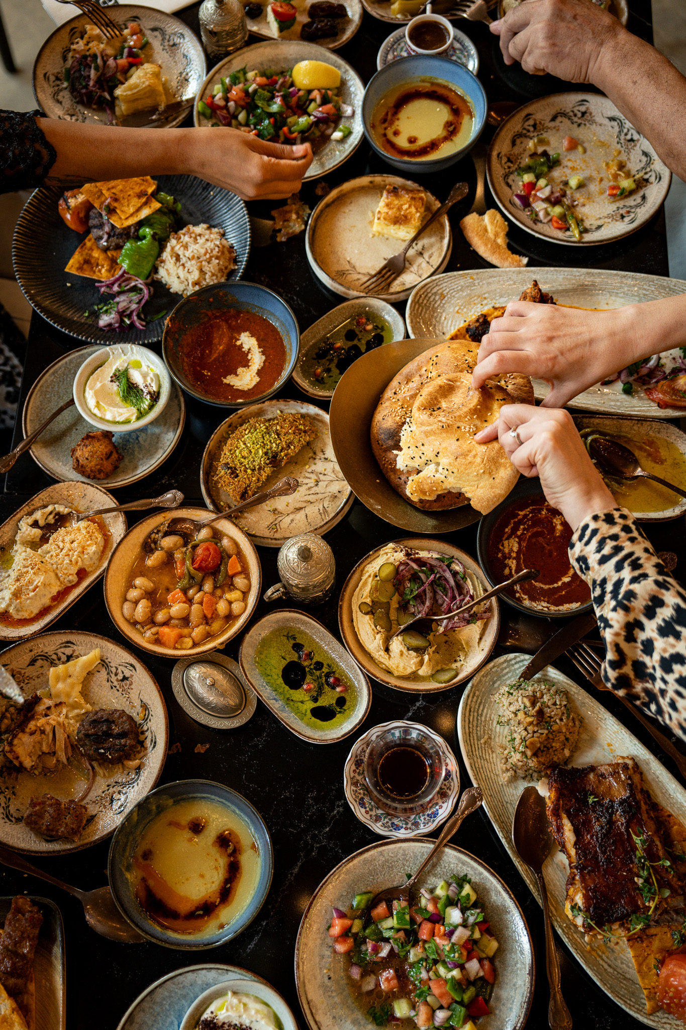Communal Iftar feast with hands breaking bread